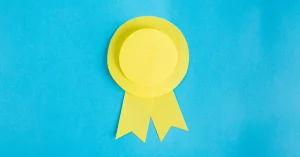 A yellow ribbon over top of a blue background
